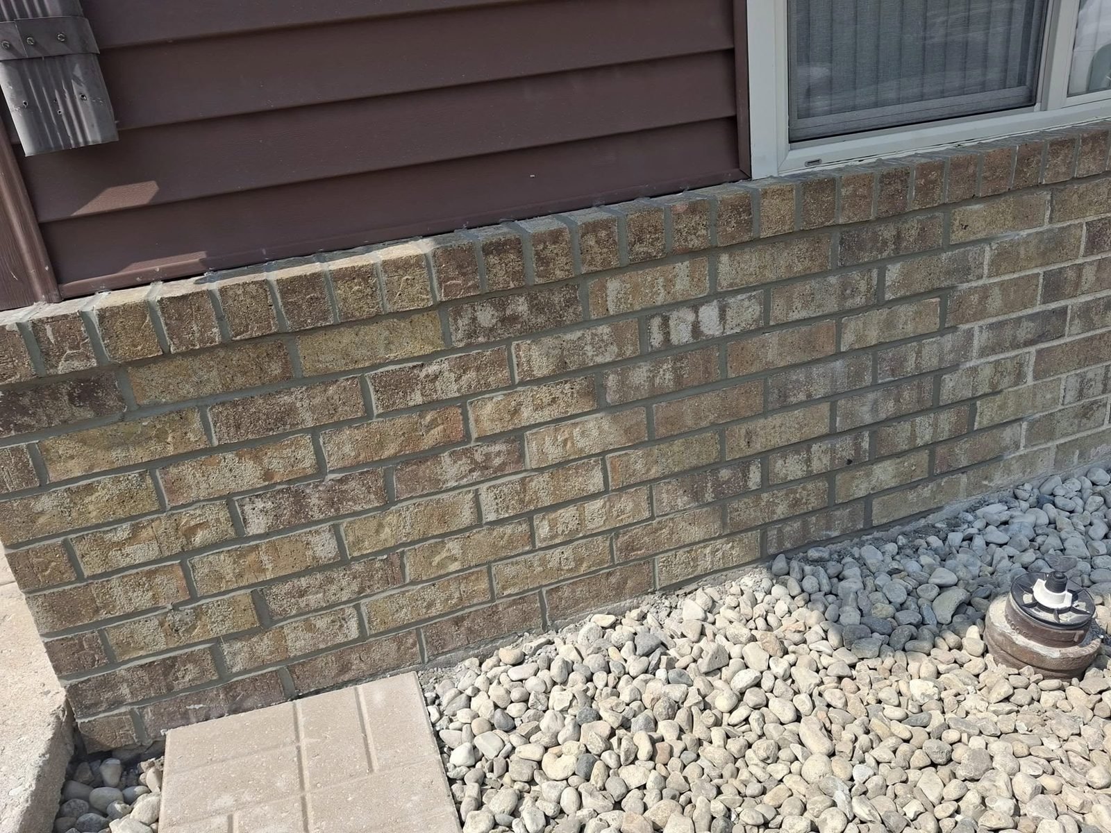 Same brick wall after tuckpointing — fresh mortar joints