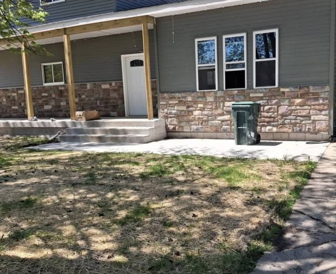 Finished stone veneer wainscot on a front porch